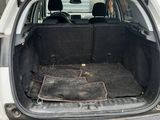 the back of a car with its trunk open and the back of the car in the back