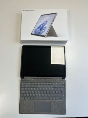 a laptop computer sitting on top of a white box
