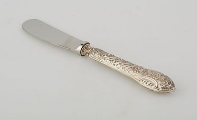 a knife that is sitting on a white surface