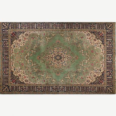 a green rug with a medallion design on it