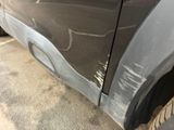 a close up of a car ' s front bumper with a denting on it
