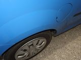 a blue car that is parked on the side of the road