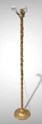 brass plated floor lamp with a glass shade and a metal base