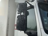 un camion blanc garé sur le bord de la route