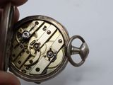 a close up of a pocket watch being held by a person