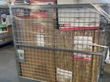 a large metal cart with boxes on it in a warehouse
