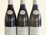 three bottles of wine sitting on top of a table next to each other
