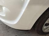 a close up of a car ' s front bumper and tire