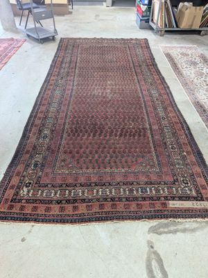 an old rug is sitting on the floor in a room