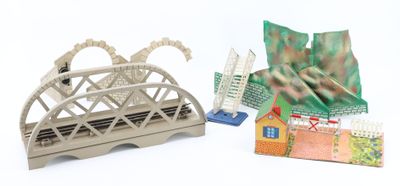 a small model of a bridge and a small model of a house