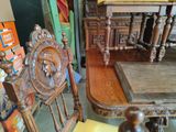 two wooden chairs and a table in a room