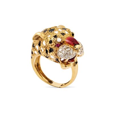 a close up of a gold ring with a red and black diamond leopard