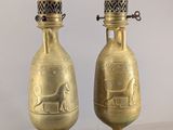 pair of antique brass vases on marble bases with a horse and carriage motif