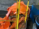 a pile of orange bags sitting on a cart in a garage