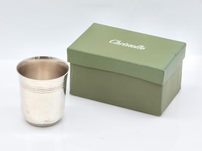 a silver cup sitting next to a box on a table