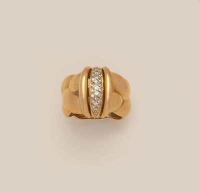 a yellow gold ring with a diamond set in the center