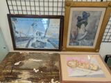 three framed pictures on a table next to each other