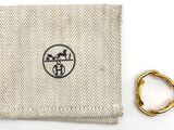 beige and white cloth with a gold ring and a ring on it