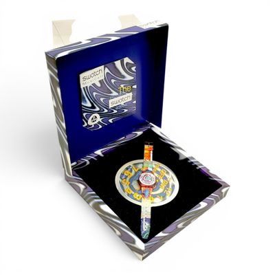 a box with a clock inside of it on a white surface