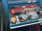 a drawer full of assorted items sitting on a table