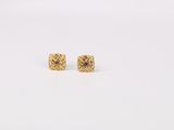 a pair of gold earrings on a white background
