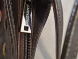 a person holding a purse with a zipper open