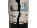 a bottle of wine that has a crack in it