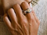 a woman that is wearing a ring on her finger