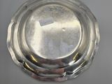 a silver plate on a table with a sticker on it