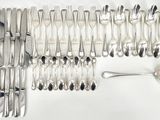many forks and spoons laid out on the table