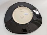 a black and white plate with a gold rim