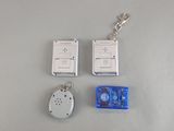 two remote controls and a keychain on a table