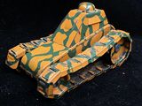 a toy tank that is sitting on a black surface