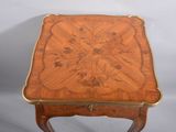 an image of a small wooden table with a floral design on the top