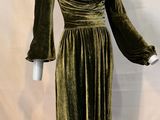 a green velvet dress on a mannequin base with a white mannequin torso