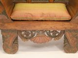 a wooden chair with a cushion on top of it