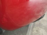 a close up of a red motorcycle with a black handlebar