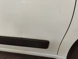 the door handle of a white car with a sticker on it