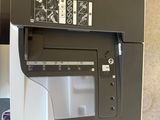 a printer that is sitting on the floor next to a laptop