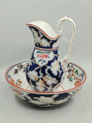 an image of a blue and white porcelain pitcher and saucer on a saucer