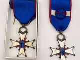 two medals that are in a box on a table