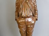 a statue of a man in a suit and tie on a pedestal