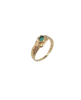 a close up of a gold ring with a green stone