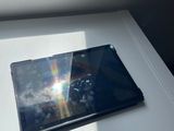 a tablet computer sitting on a table in front of a window