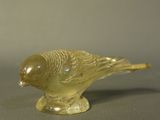 une figurine d'oiseau jaune posée sur une table