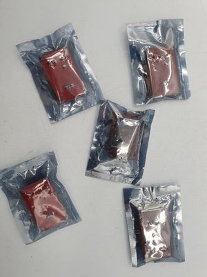 four packets of chocolate sitting on top of a white table