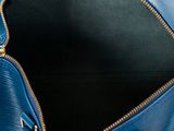 the inside of a blue handbag with a zipper open