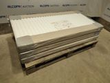 a pile of paper on a pallet in front of a wall