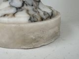 a marble statue of a cat on a pedestal