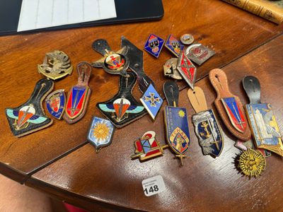 a lot of badges on a table next to a laptop